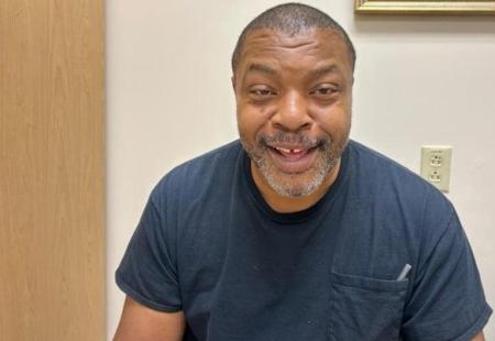 Man smiling at doctor’s office after beating esophageal cancer 